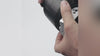 S3X Remote held in one hand while a spotlight bracket is fitted
