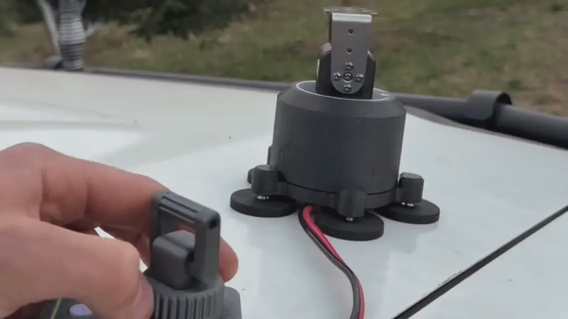 S3X on a magnetic base being aimed with the handheld remote